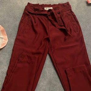 Red women’s dress pants with side zipper.